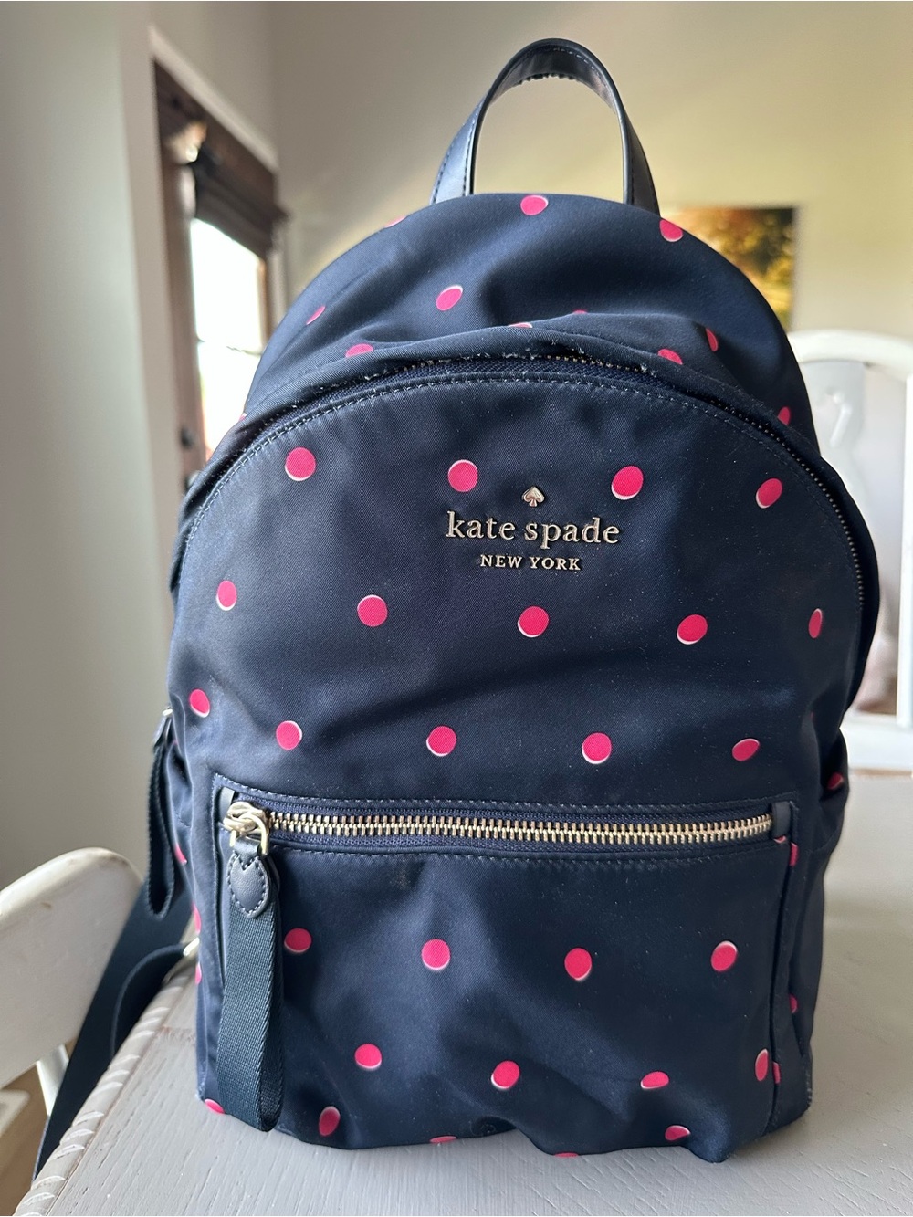 kate spade navy backpack with bright pink polka dots